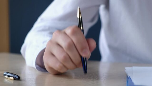 Boss or teacher knocks on the table with a pen urging silence