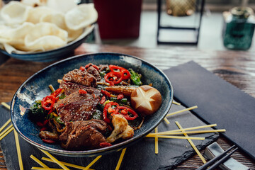 plate with grilled beef vegetables and chili, chopsticks