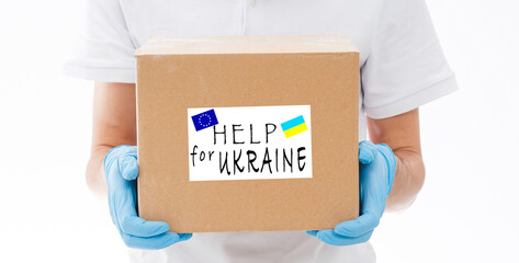 A man holds a box of aid for Ukrainian refugees and poor citizens who find themselves in a war...