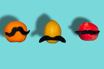 lemon, apple and orange in the air, creative concept with a more beautiful mustache, fashion food design with shadows