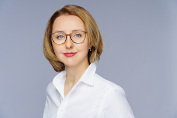  woman in casual posing over white studio background. Portrait of cheerful successful middle aged business lady
