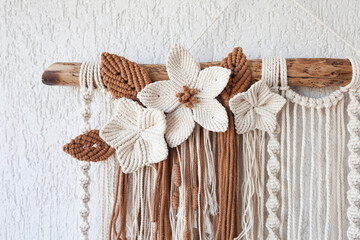 Handmade macrame wallhanging. 100% cotton wall decoration with wooden stick hanging on a white...