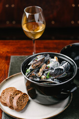 Mussels in a creamy sauce with parsley, baguette and white wine.