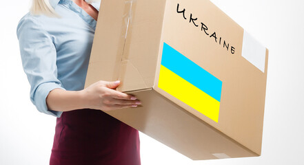 A man holds a box of aid for Ukrainian refugees and poor citizens who find themselves in a war...