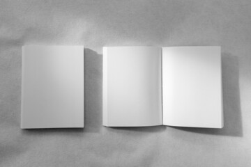 Mockup of brochure with fold. Blank mock up of booklet, menu and book. White paper of magazine. Mockup of leaflet. Template of twofold pamphlet isolated on white background.