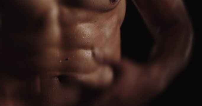 Touching his body and flexing, tilt shift