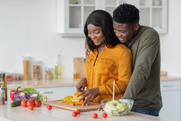 Portrait Of Romantic African American Couple In Kitchen Cooking Lunch Together