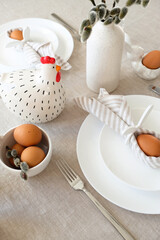 Easter table setting with egg in Easter bunny napkin and cutlery