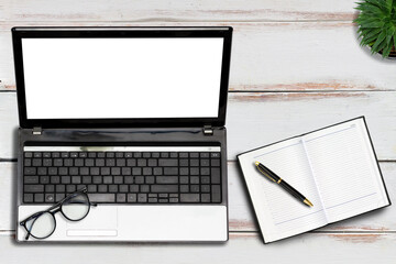 Laptop with glasses, notepad, pen and succulent on the wooden background. Mock up with copy space....