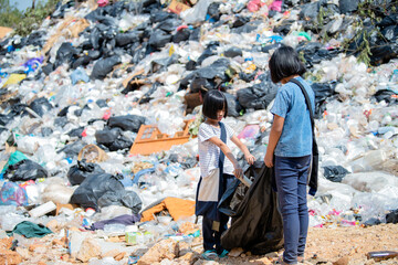 A group of poor children collecting garbage for sale, pollution and environment concept, recycling old waste, world environment day