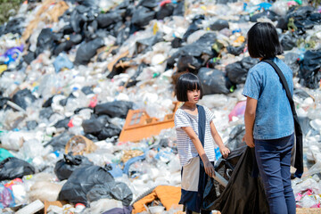 A group of poor children collecting garbage for sale, pollution and environment concept, recycling...
