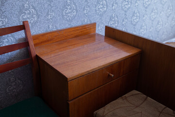 old bedside table in a poorly renovated room