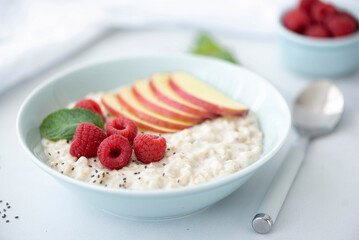 oatmeal bowl with apple, raspberry and cinnamon