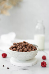 chocolate flakes breakfast balls in a white bowl