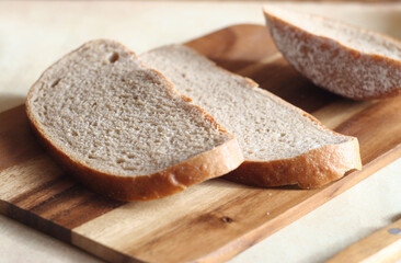 Sliced bread lies on a wooden board.  Farm product
