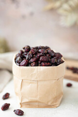 dried berries of large wild rose in a craft bag