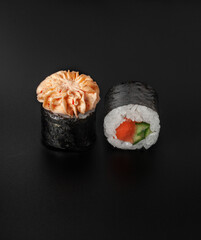 lava maki sushi with salmon on black background closeup