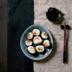 Homemade sushi rolls set with salmon, japanese omelette, avacado and soy sauce