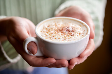 woman with cup of cappuccino
