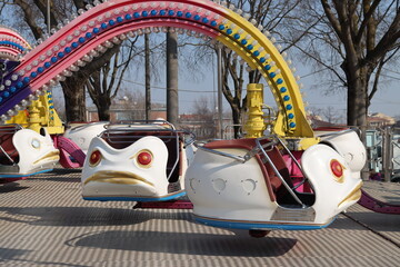 amusement park carousel with funfair seats