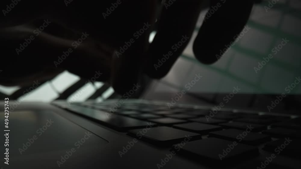 Wall mural man writes message to social network. male hands typing on notebook keyboard in dark . writer writes