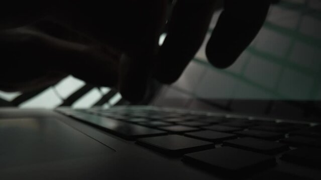 Man writes message to social network. Male hands typing on notebook keyboard in dark . Writer writes article in media. Working on laptop, typing on keyboard, online business. Close up. Slow motion.