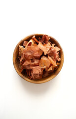 Onions for dyeing eggs. Onion husks in a wooden plate on a white background. Preparing for Easter.