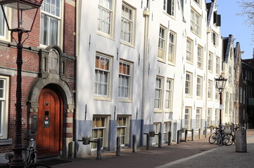 Amsterdam Spui Street View with Historic House Facades and Begijnhof Courtyard Entrance, Netherlands