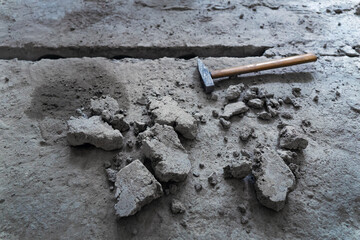 Dismantling floor in apartment. Clearing seam between concrete slabs. Removal of dust and debris...