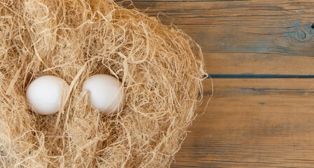 White eggs put on a pile of straw   Eggs contain vitamins, phosphorus, zinc.