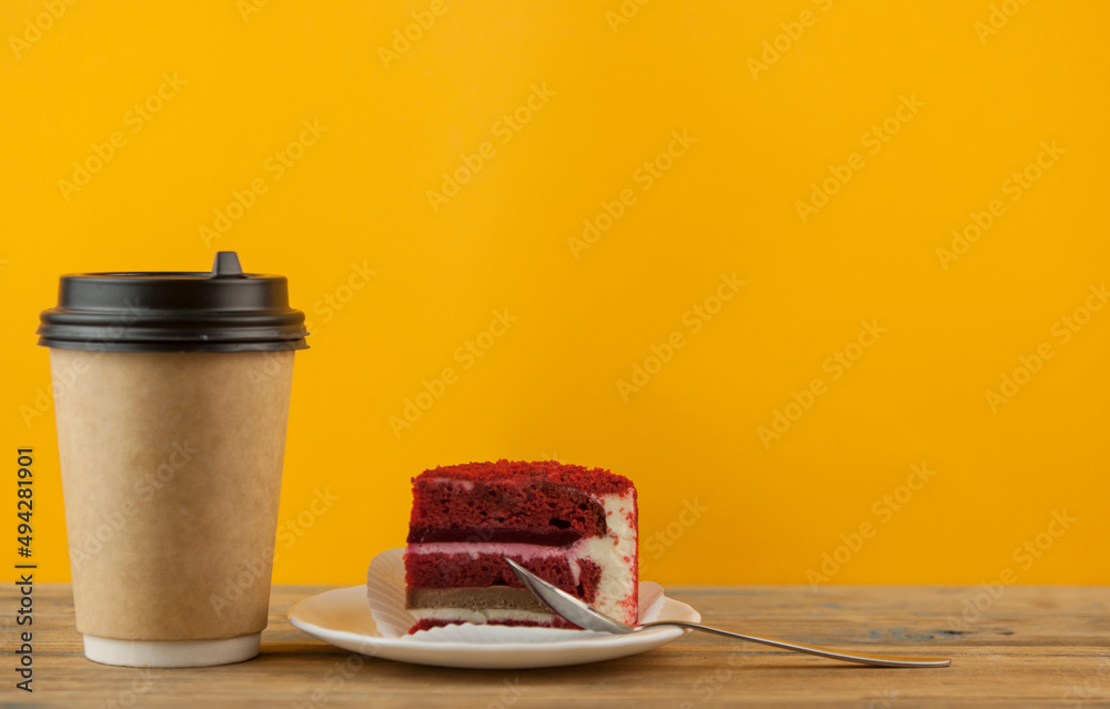 Wall mural Red velvet cream cheese with black coffee in paper cup, Wood background.