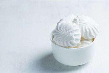 Vanilla Marshmallow dessert zephyr. Airy Meringue dessert in a white bowl on the white background. traditional Russian sweet dessert. copy space