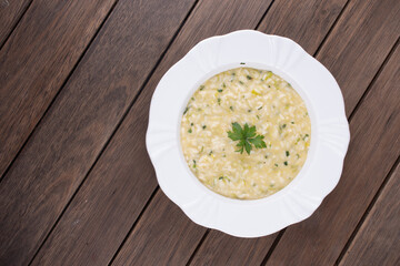 risotto with parsley viewed from above on rustic wooden table