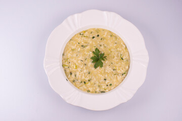 risotto with green onions on wooden table top view