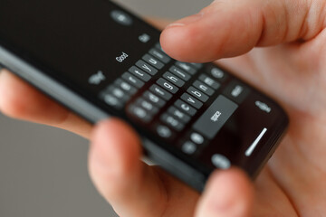 close-up man typing text on smartphone