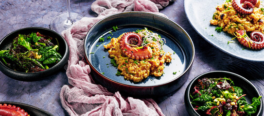 A portion of risotto with octopus tentacles. purple background. Top view