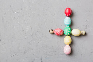 holiday preparation Multi colors Easter eggs on colored background, cross show the religious and secular side of Easter. Pastel color Easter eggs. holiday concept with copy space