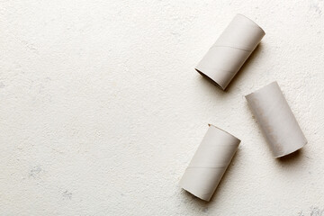 Flat lay composition with empty toilet paper rolls and space for text on color background. Recyclable paper tube with metal plug end made of kraft paper or cardboard