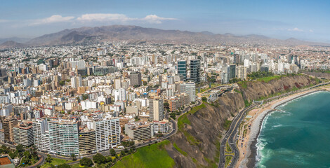 LIMA, PERU: Aerial view of Miraflores town, cliff and the Costa Verde high way