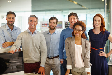 Meet the team. Portrait of a diverse team of professionals working in an office.