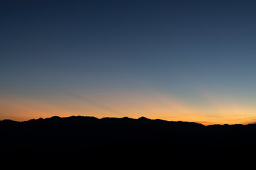 The sunset skies from blue to orange with stunning colors.