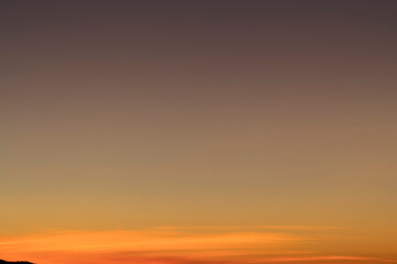 The sky before dawn was clear with an orange horizon and a blue atmosphere. orange dawn sky smooth orange gradient background of the start of the day Morning paradise with copy space. Sunset. Sunrise 