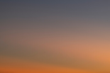 The sky before dawn was clear with an orange horizon and a blue atmosphere. orange dawn sky smooth orange gradient background of the start of the day Morning paradise with copy space. Sunset. Sunrise 