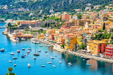 Fototapeta na wymiar Panoramic view of beautiful luxury resort and bay on hills leading down to coast of French riviera Ville is situated between Nice city and Monaco. Vibrant Travel Concept. Mediterranean Sea