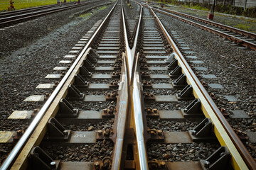 Fototapeta premium Grunge steel railroad tracks with separate train crossings.