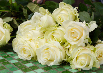 A beautiful bright bouquet of blooming fresh roses for a gift collected by an experienced florist