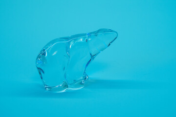 Crystal glass polar bear on blue background.