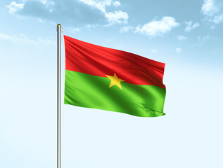 Obraz premium Burkina Faso national flag waving in blue sky with clouds. Burkina Faso flag. 3D illustration
