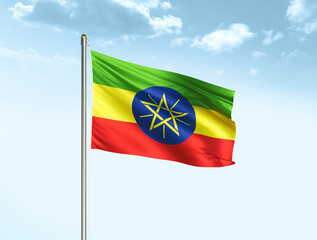 Ethiopia national flag waving in blue sky with clouds. Ethiopia flag. 3D illustration