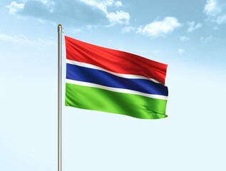Gambia national flag waving in blue sky with clouds. Gambia flag. 3D illustration